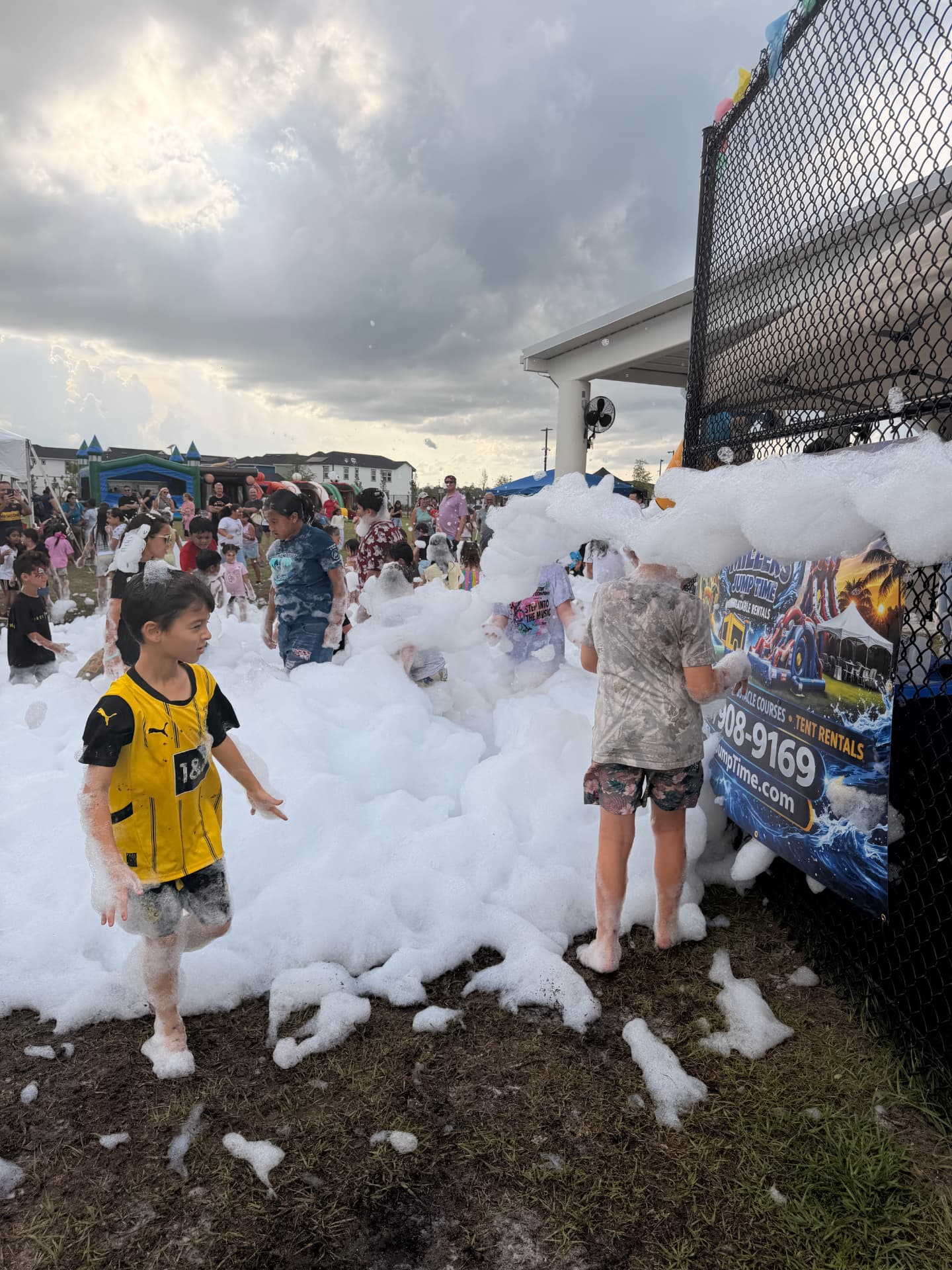 Students covered in foam next to the Millers Jump Time foam zone