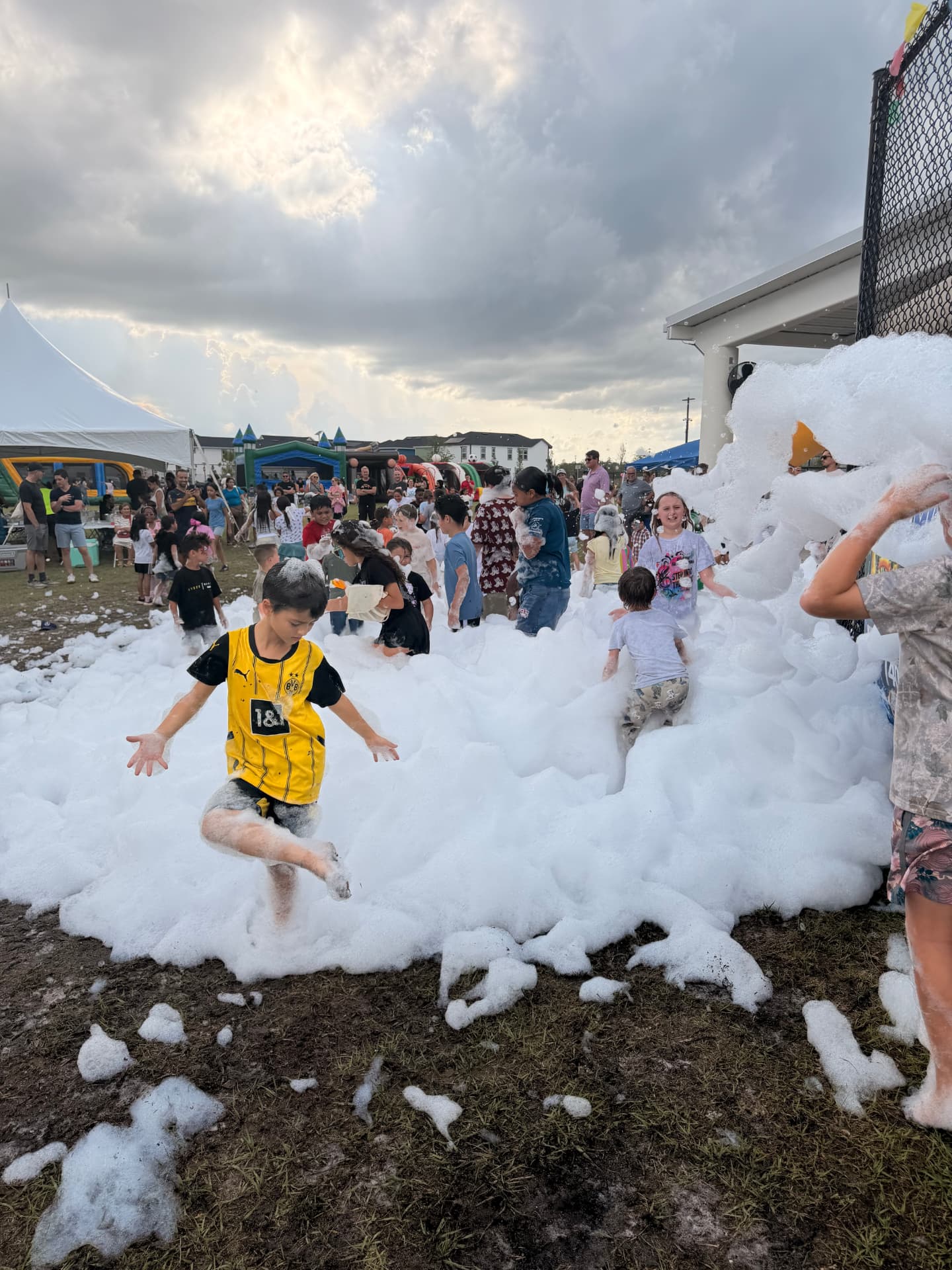 Student jumping through deep foam at a school foam party