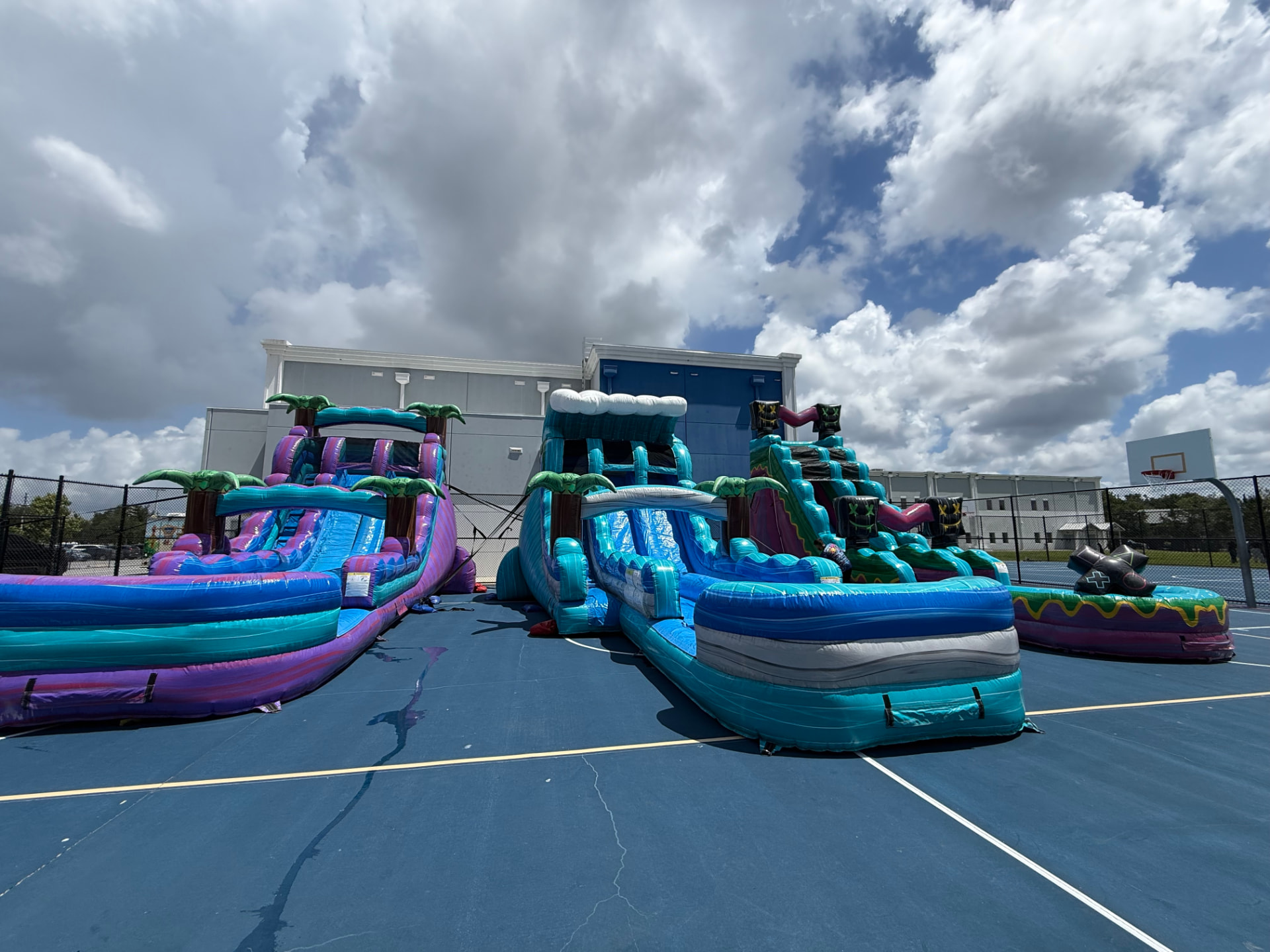 Bounce Hype crew setting up inflatables on a school field