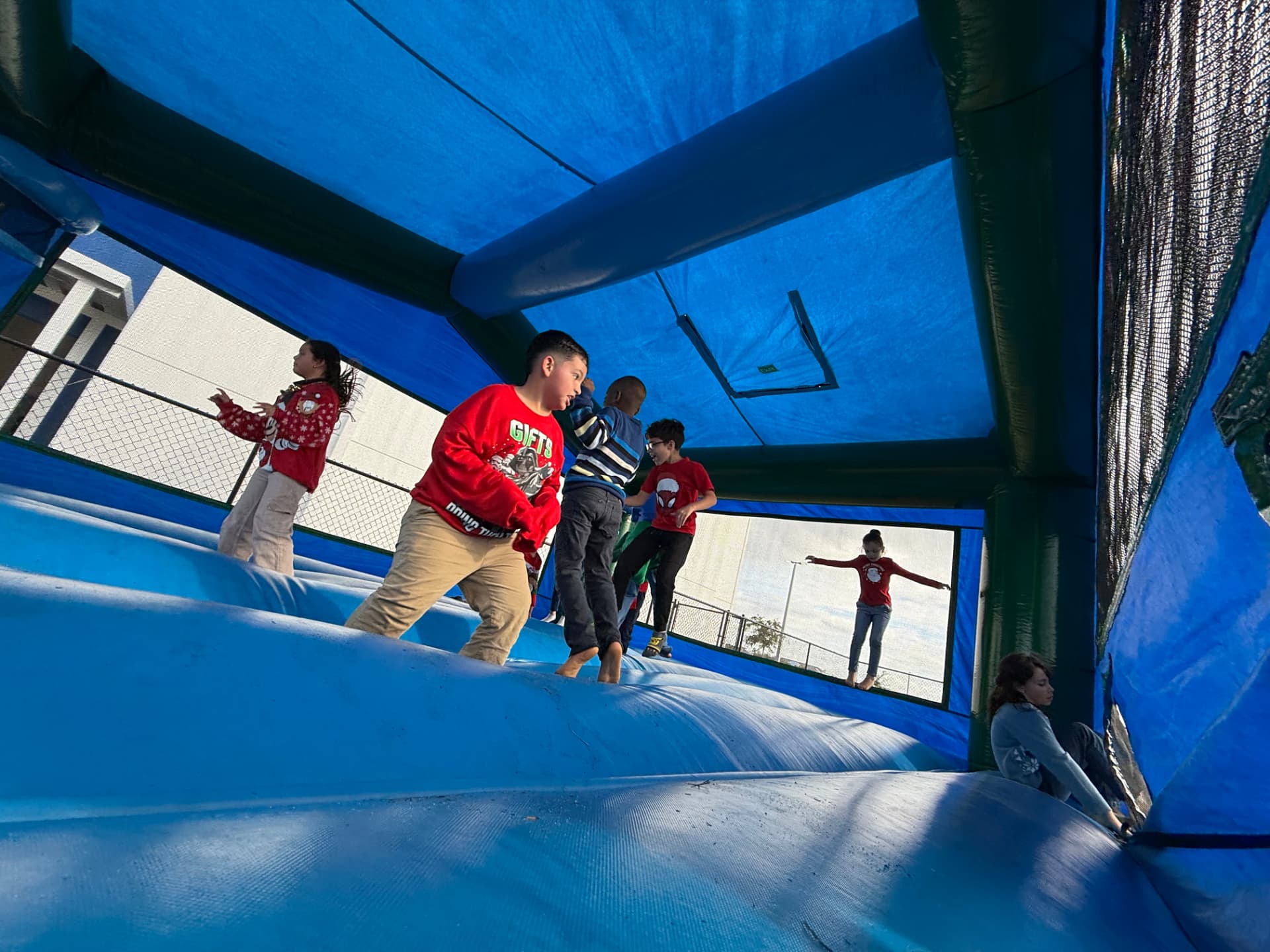 Students waiting their turn at a Bounce Hype slide